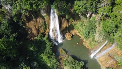 A-beautiful-drone-shot-flying-away-from-Thi-Lo-Su-Waterfall-and-seen-from-above,-off-the-beaten-track-in-the-jungle-of-North-Thailand-in-the-area-of-Umphang-in-Southeast-Asia