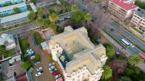 Aerial-dolly-in-of-Frech-Style-Carrasco-Palace-surrounded-by-palm-trees-ViÃ±a-del-Mar,-Chile