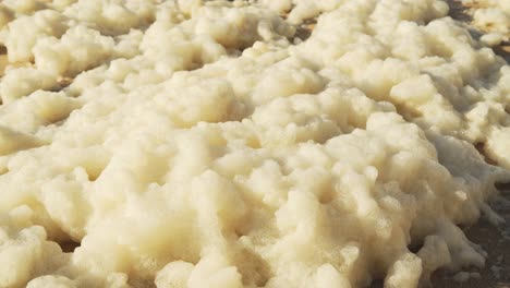 Sea-Foam-on-a-Sandy-Beach-on-the-Atlantic-Coast-of-Portugal-at-Sintra,-Lisbon,-Europe-1