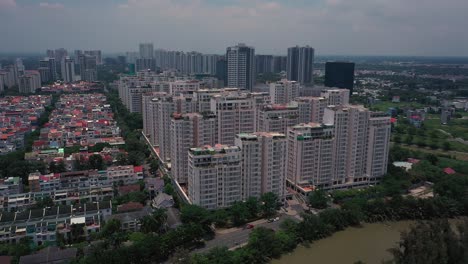 Aerial-suburban-view-on-sunny-day-with-large-apartment-and-housing-development-on-river-1