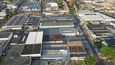 Aerial-of-buildings-with-solar-panels-on-rooftop-at-a-large-industrial-terrain