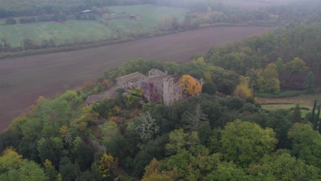 Flying-away-from-old-Italian-castle-into-clouds,-Castello-of-Montalto