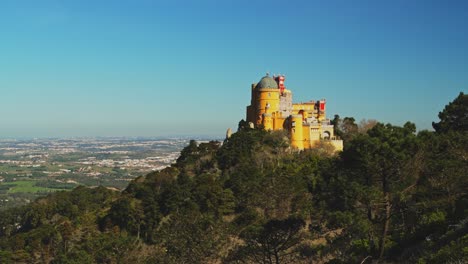 Aerial-Drone-View-of-Pena-Palace,-Sintra,-Lisbon,-Portugal,-and-the-beautiful-forest-and-mountain-landscape,-UNESCO-World-Heritage-Site-Architecture-and-Popular-Tourist-Attraction,-Europe-1