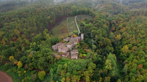 Picturesque-castle-in-Tuscany-surrounded-by-thick-lush-forest-on-cloudy-day