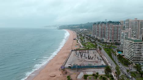 Dolly-in-aerial-view-of-ViÃ±a-del-Mar's-coastline-and-a-construction-site-abandoned-due-to-unissued-permits