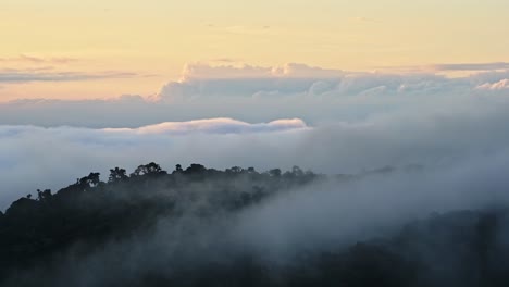 Costa-Rica-Misty-Rainforest-Landscape-with-Mountains-and-Low-Lying-Mist-and-Clouds-Rolling-Through-Valley-in-Orange-Sunset-Dramatic-Beautiful-Light,-Los-Quetzales-National-Park