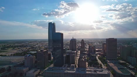 4K-Drone-footage-of-Oklahoma-City-skyline,-during-sunset,-with-big-rain-clouds-in-the-background