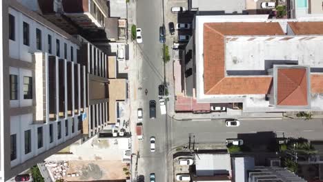 Top-shot-of-drone-capturing-city-streets-with-traffic-in-residential-area