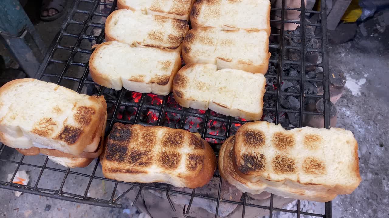 Premium stock video - A cook is shown in a video toasting buttery ...