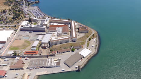 An-aerial-view-of-the-San-Quentin-State-Prison-then-pull-back-and-tilt-up-to-reveal-the-Richmond-San-Rafael-Bridge