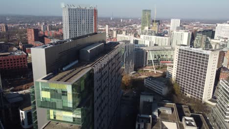 Aerial-drone-flight-over-the-Manchester-Justice-Centre-showing-a-view-of-the-surrounding-rooftops-and-streets-below