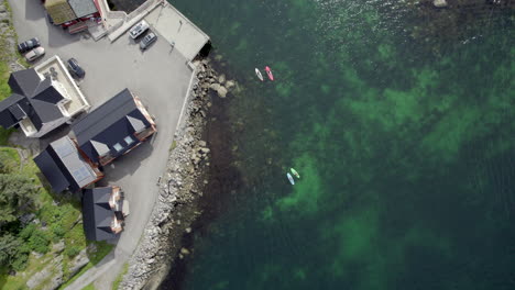 Overhead-shot-of-stand-up-paddlers-at-Hamnoy-on-Lofoten-Islands-in-Northern-Scandinavia