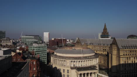 Aerial-drone-flight-along-the-enire-length-of-Oxford-Road-in-Manchester-City-Centre-from-the-University-of-Manchester-to-Albert-Square-giving-a-view-of-the-rooftops-along-the-way