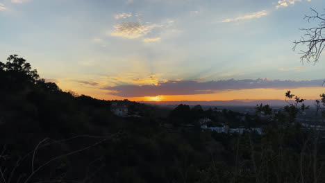 Hiking-Trail-View-Of-The-Sun-Setting-Behind-Mountains-Against-Blue-Sky-With-Clouds-In-Los-Angeles,-California