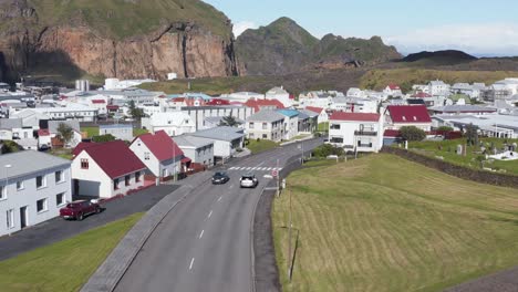 Car-driving-in-small-town-on-remote-volcanic-island,-VestmannaeyjabÃ¦r