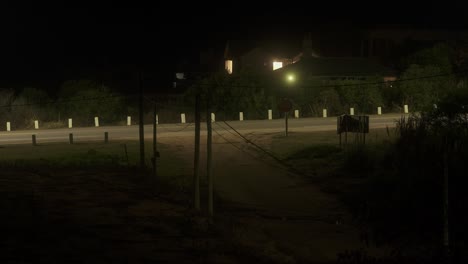 Time-lapse-shot-of-traffic-on-rural-road-at-night-in-Punta-del-Este-in-Uruguay