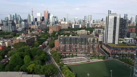 Drone-shot-of-downtown-Toronto-Skyline-with-soccer-field-in-foreground