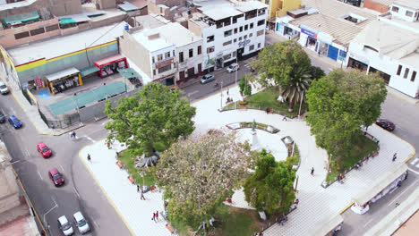 Amazing-drone-shot-over-the-famous-"Plazuela-de-ElÃ­as-Aguirre"-park-in-the-city-of-Chiclayo,-Peru-during-a-cloudy-day-with-cars-passing-by