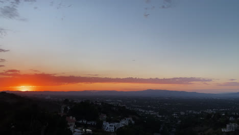 Mountain-View-Of-The-Sun-Setting-Behind-Mountains-Against-Blue-Sky-With-Clouds-In-Los-Angeles-on-a-hiking-trail,-California-1