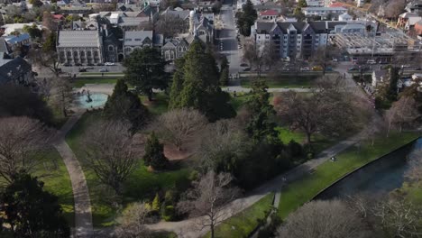 Spectacular-aerial-reval-over-Botanic-Garden,-historic-Anglican-buildings-to-central-city