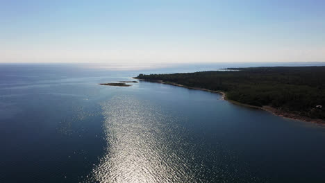 Aerial-view-of-the-coastline-of-west-Aland,-sunny,-summer-day-in-Finland---tracking,-drone-shot