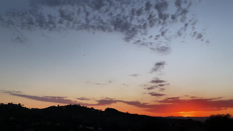 Mountains-silhouetted-against-red-and-blue-sky-just-after-the-sun-has-set-and-the-sky-is-blue-and-red-In-Los-Angeles,-California