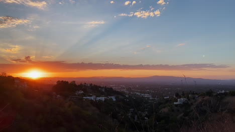 Mountain-View-Of-Scenic-Sun-Setting-Against-Blue-Sky-With-Clouds-and-Houses-in-the-Distance-In-Los-Angeles,-California