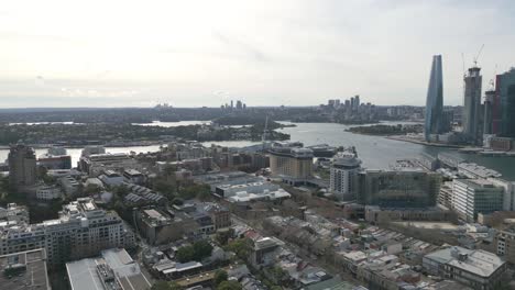 Drone-flying-over-city-of-Sydney-toward-Barangaroo-on-a-cloudy-day