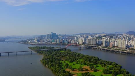 Drone-shot-traveling-forward-above-the-Han-river-to-the-Bamseom-island-in-Seoul-city-during-a-sunny-day