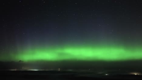 Aurora-Borealis,-Northern-lights,-foggy,-fall-night-on-the-countryside-of-Finland---aerial-hyperlapse-shot