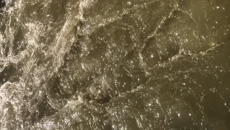 VERTICAL-stream-of-fast-white-water-river-current-on-a-sunny-day