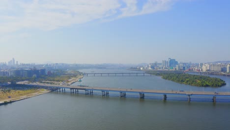Drone-shot-traveling-backward-above-the-Han-river-from-the-Mapo-bridge-in-Seoul-city-during-the-day
