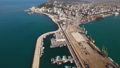 Port-aerial-view-on-coastline-of-Adriatic-near-Durres-city,-anchored-boats-and-ships