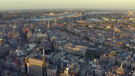 Drone-shot-over-Amsterdam-Central-red-light-district-at-sunset-golden-hour