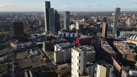 Aerial-drone-flight-from-Oxford-Road-to-Deangate-showing-the-rooftops-below-and-the-skyscarpers-in-the-distance-in-Manchester-City-Centre