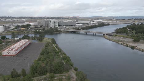 Aerial-view-of-Sydney-International-Airport-from-Cooks-River-at-Tempe-recreation-reserve,-Wolli-Creek,-New-South-Wales,-Australia