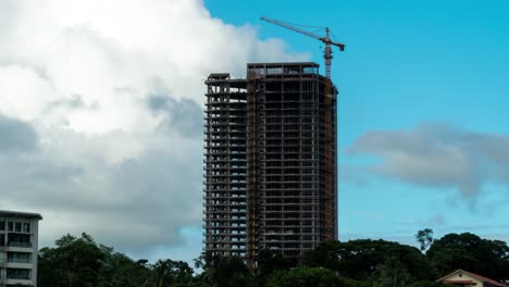 Construction-of-Wyndham-hotel-tower-in-Fiji-Capital-Suva,-clouds-forming-in-background,-timelapse