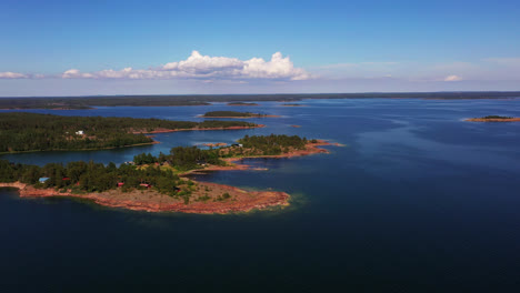 Aerial-view-overlooking-islands-in-the-Aland-archipelago,-sunny-summer-day-in-Finland---circling,-drone-shot