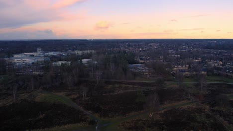 Groevenbeekse-Heide-nature-park-aerial-view-at-sunset,-rising-up,-Netherlands
