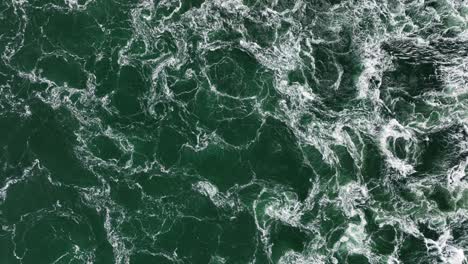 Dark-murky-water-swirls-in-strong-storm-surge-barrier-current-in-Holland