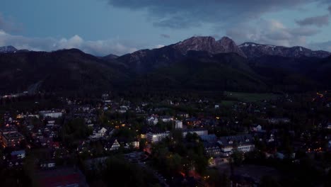 Evening-flyover-of-Zakopane,-Poland,-a-resort-town-against-the-Tatra-Mountains,-and-its-stunning-Goral-traditional-architecture