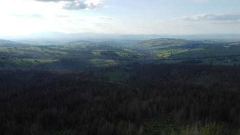 Landscape-flyover-of-Polish-Tatry-Mountains,-plains