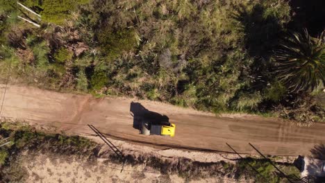 Uruguay_Punta-del-Este-Beach-a-dirt-road-leveling-machine-at-work-on-a-sandy-road