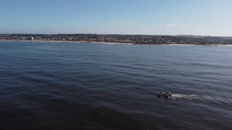Side-view-drone-shot-of-a-fishing-boat-in-the-ocean-off-Uruguay