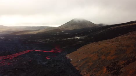 Aerial-landscape-view-of-Meradalir-valley,-Iceland,-with-Fagradalsfjall-volcano-erupting