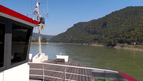 Famous-Danube-Wachau-cruise-frontal-ship-view-with-river-and-forest-in-summer