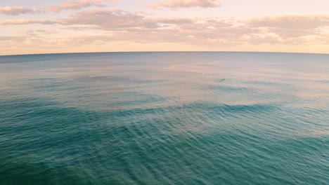 Cinematic-aerial-view-of-ocean-waves-near-the-coast,-vast-water-surface