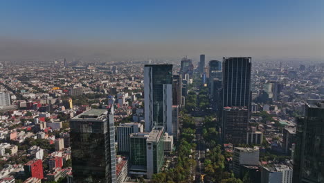 Mexico-City-Aerial-v39-drone-fly-above-paseo-de-la-reforma-capturing-downtown-cityscape-across-juarez-and-colonia-cuauhtemoc-neighborhoods-on-a-hazy-day---Shot-with-Mavic-3-Cine---December-2021