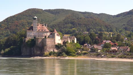Typical-Austrian-castle-on-banks-of-the-Danube-river-seen-from-Wachau-river-cruise