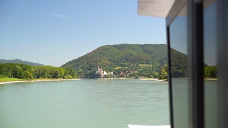 Frontal-view-from-ship-passing-along-big-river-on-sunny-day